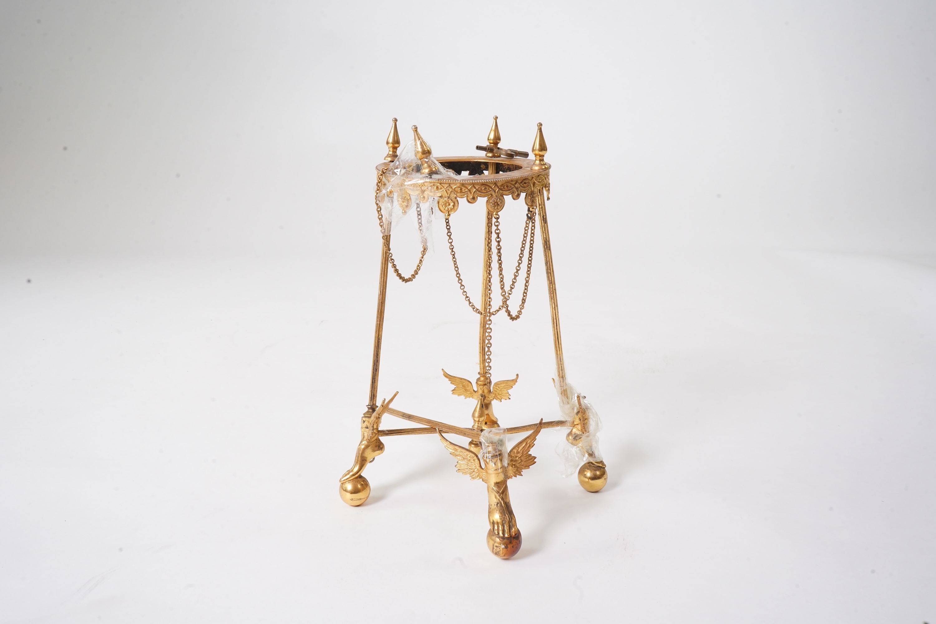 An unusual enamel and gilt brass timepiece, pendant from gilt brass frame, stand 26cm high. Condition - dismantled